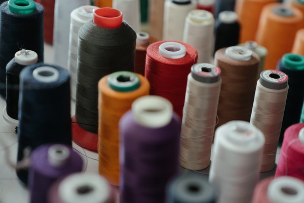 Examples of different thread types and thicknesses used in belt stitching.
